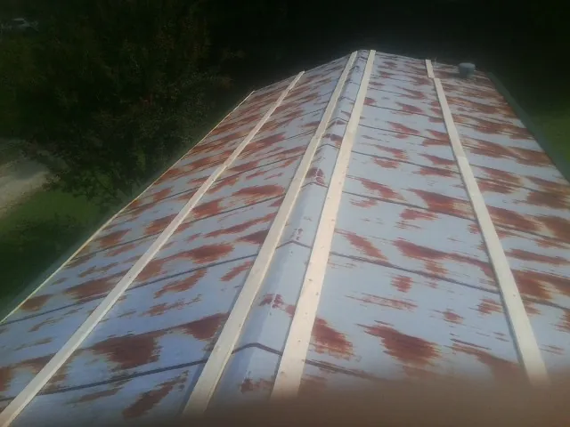 Rusted metal roof panels with new wood purlins before replacement — Storm Damage Roof Repair in Poulan by Roofing Brothers